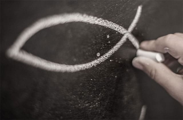 Person writing with chalk